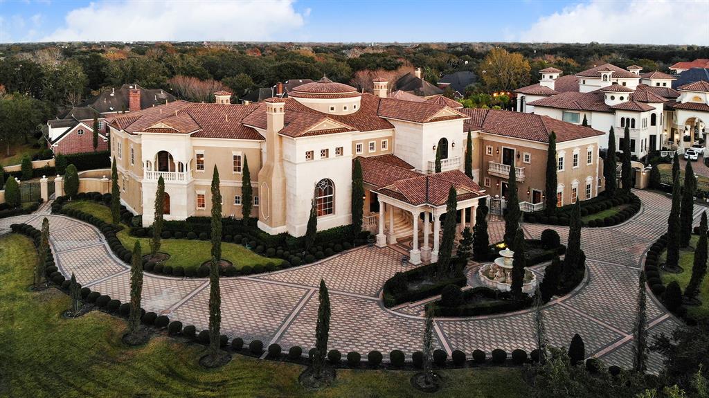 Superbly positioned on approximately 1.68 acres, this exquisite palatial style residence offers over 19,000 square feet (per appraisal district) of rare opulence. Enter the front gates to the columned and covered driveway entry area. A grand entry foyer features dual sweeping marble staircases with rotunda ceiling and Tiffany-style glass domed ceiling, dramatic chandelier, and central fountain. Constructed with many detailed and intricate moldings, marble floors, Venetian plaster walls, custom cabinetry and ornate finishes, gold leaf accents, and crystal chandeliers. The floor plan offers grand formal entertaining areas, large dining room, island kitchen which opens to family and breakfast area, 1st floor primary with luxurious bath and huge closet, elevator, a home theater with tiered seating and large screen, and lavish secondary bedrooms. The focal point of the back patio is the sparkling pool with water features and flaming corner fixtures. Truly magnificent Sweetwater showplace!