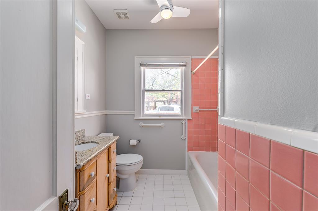 Bathroom between both bedrooms. Features colorful tile and ceiling fan. More amazing natural light.