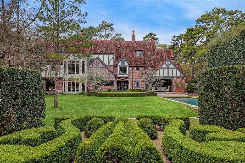 This Cotswold/ Tudor style home is just over 11,000 square feet located on 1.5 pristine acres. Built with a keen attention to detail, this home was crafted to combine Old English tradition with modern day amenities. Antique features include 150-year-old American chestnut flooring, lighting from the 17th-19th century, antique pine beams and numerous architectural elements from Chateau Domingue. The chef’s kitchen includes Subzero and Viking appliances while a downstairs game room, wine room and wet bar provide plentiful spaces for entertaining. Each room offers impeccable highlights not limited to Leuder’s limestone, marble countertops, and various reclaimed materials. Outdoors you will find a large, saltwater pool and spa, a covered outdoor kitchen, and ample greenspace framed by meticulously maintained landscaping. Authentic landscaping reminds you of the English countryside. 4-car garage and motor-court.