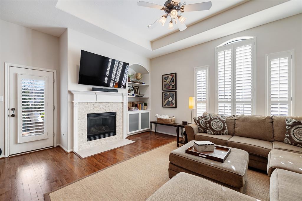 This generous living room has many luxury touches, including a fireplace. recessed ceiling, and a recently added built-in bookcase. You will also find hardwood floors throughout the main living area.