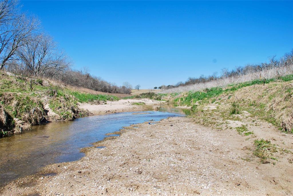 Lavaca River frontage, recreational & hunting properties are hard to find. Explore the banks of the river, enjoy watching the abundant wildlife roaming on the property. Hunting is allowed on this 48.21+/- tract of land. The property has steel livestock pens, an old barn, an equipment shed & is currently being used for livestock grazing. Horses & other livestock are welcome. The old home is uninhabitable but some of the old wood may be repurposed.  There is an ag exemption in place, the property taxes are low. Has electricity & a water well. A survey is needed to determine the exact acreage & the price will be adjusted accordingly. The property is located within the 100 year floodplain. No minerals convey. There is additional acreage available also. Conveniently located within five minutes of Hallettsville (Lavaca County) and approximately 2 hrs from Houston & San Antonio. Easy commute & access from I-10.