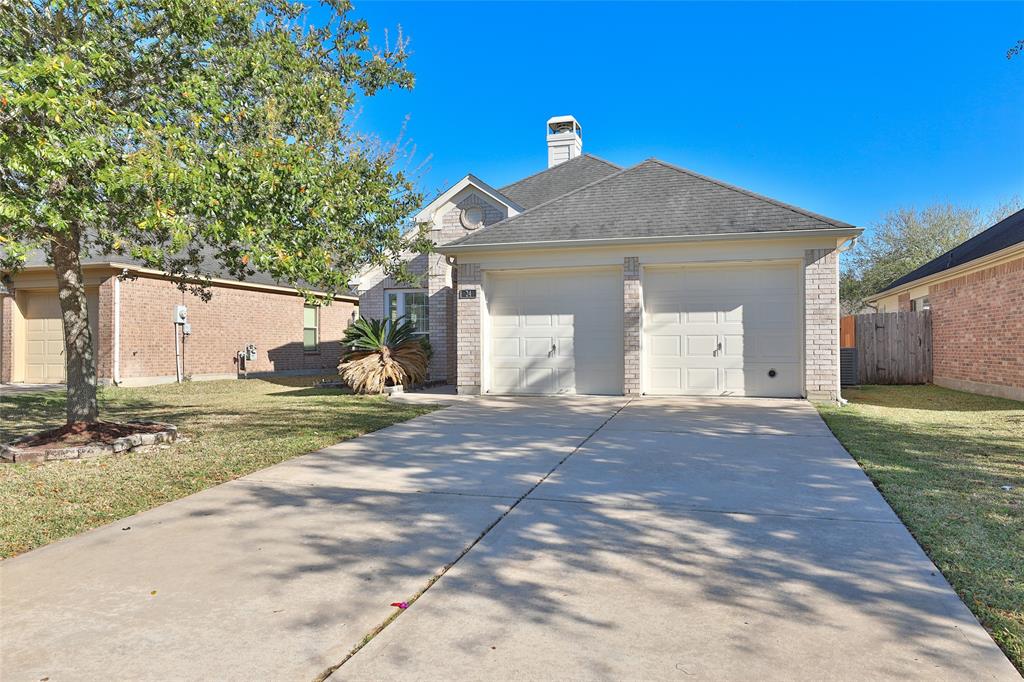 Two car garage with spacious private driveway for extra parking.