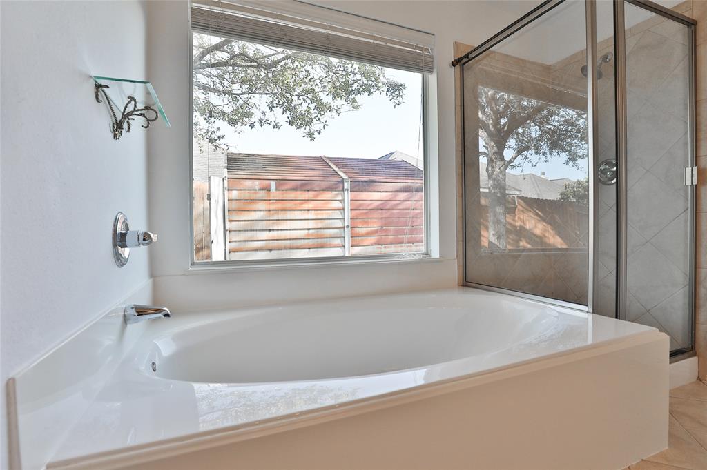 The en-suite bathroom has a large soaking tub and separate shower.