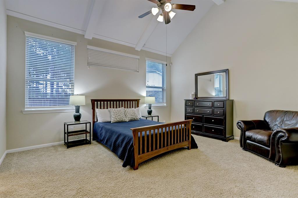 A spacious primary bedroom that feels even larger than it is thanks to vaulted ceilings.