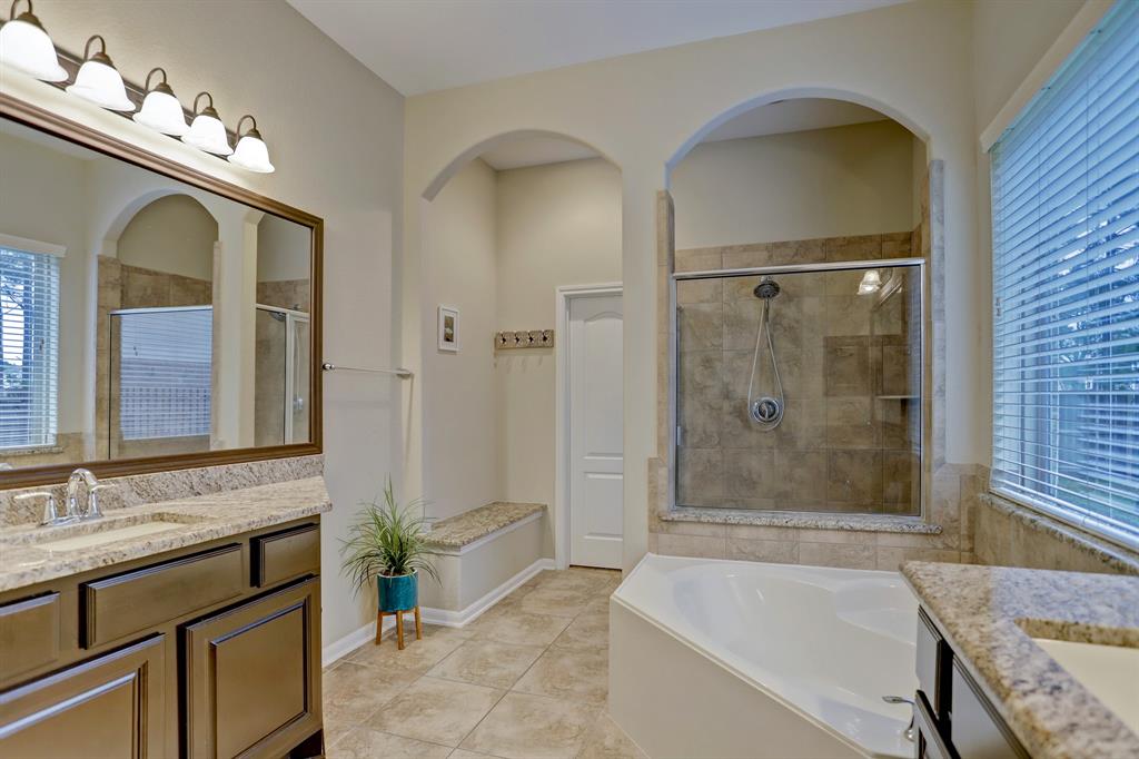 The granite bench seat across from shower is great but so is that large, artful tub.