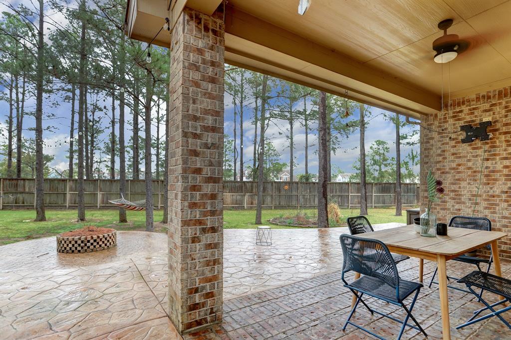 Such a spectacular outdoor setting with multiple seating and entertaining areas! Upgraded/finished floor under covered patio with huge uncovered patio. A walkway on the side leads to the front of house.