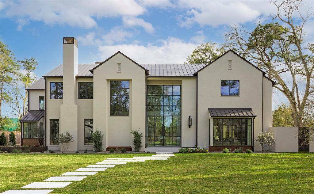 This stunning modern Napa inspired home was designed by Ryan Gordon, built by Thompson Custom Homes and interiors selected by Benjamin Johnston Design. Live in the safest city in Texas with Memorial Villages Police Department and Village Fire Department just minutes away. This home is filled with all the details you expect in a custom home: a grand two-story, light-filled entry featuring 21-feet tall custom steel units that allow views to the back yard, pool, majestic live oak and expansive property behind the lot. This new construction also features a party room with two conditioned wine closets, a large outdoor living and kitchen area, Gaggenau appliances, European oak flooring, a private primary suite,  and a downstairs flex room that can function as an exercise room, office or bedroom.