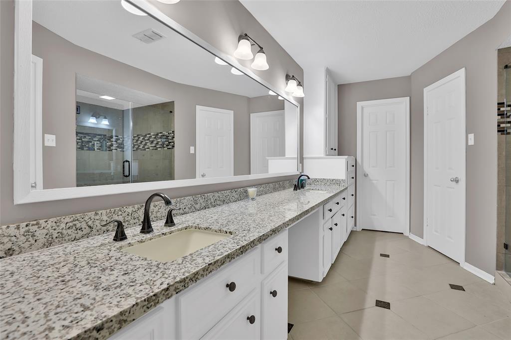 The en-suite bathroom has double sinks and two walk-in closets.
