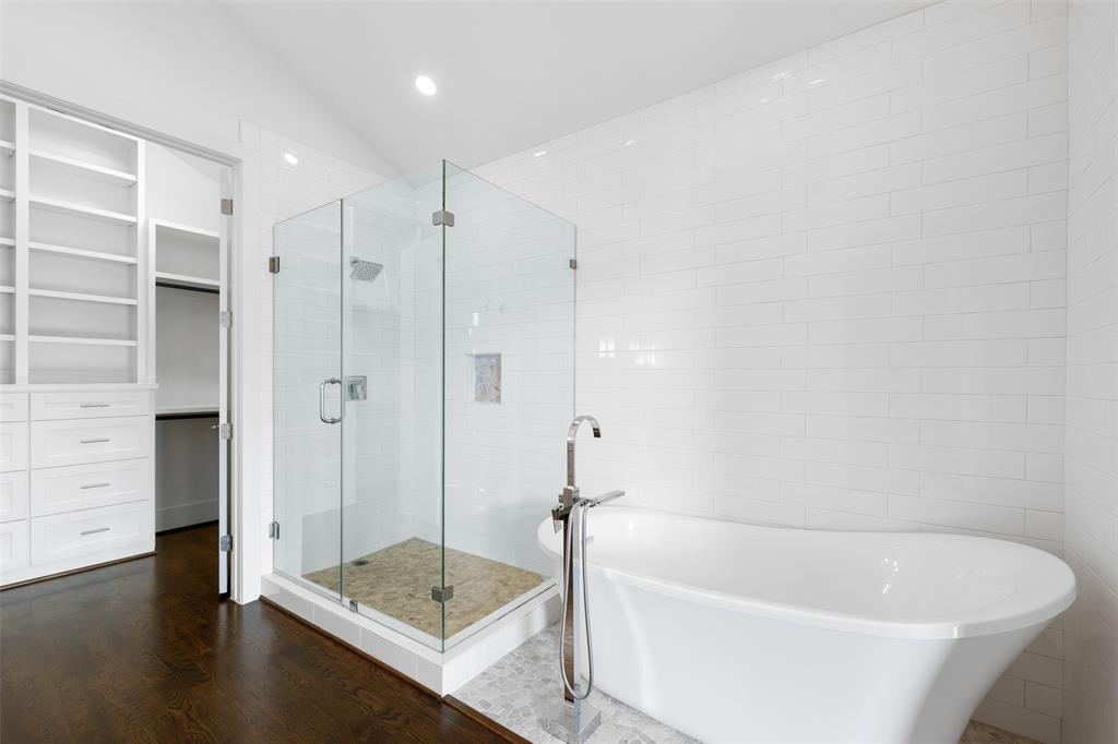The primary bathroom includes a stand alone soaking tub and huge seamless shower.