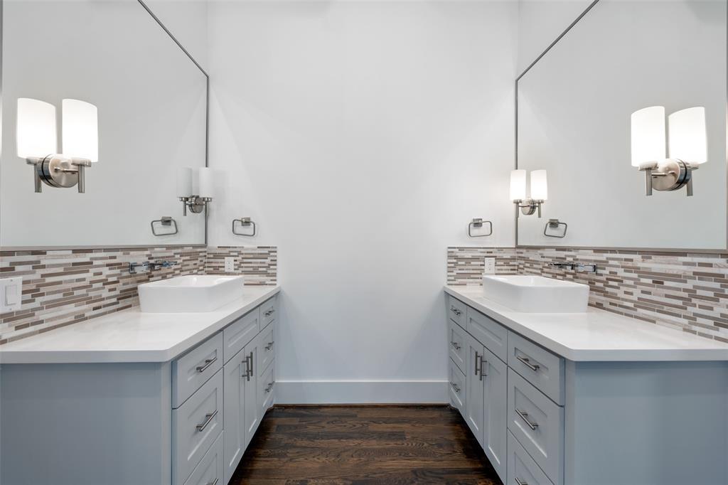 The primary bathroom also includes double vanities with lots of storage and quartz countertops.