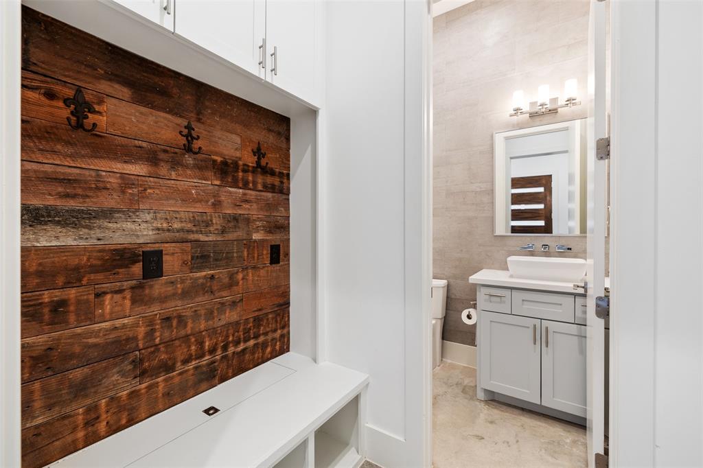 This mudroom is located right off the garage and entry way.  It is also next to the 1st floor half bathroom. The mudroom provides custom storage for coats and shoes.