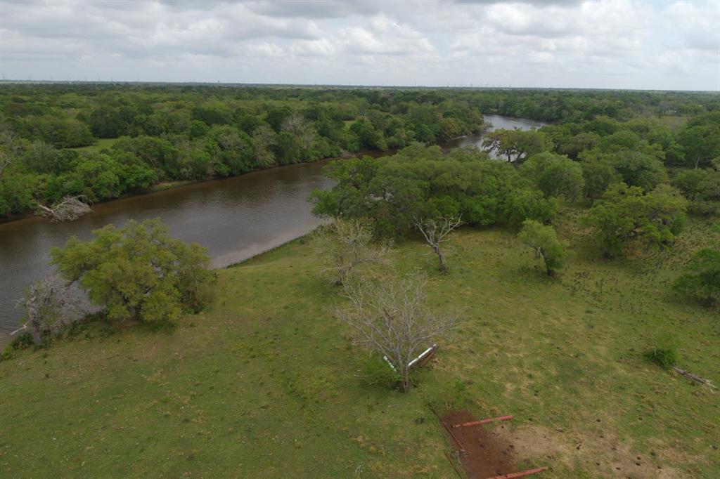 44 ACRES OF ABSOLUTELY BEAUTIFUL RIVERFRONT PROPERTY!   877' of frontage on the San Bernard River, ag exempt.    The property is partially cleared, taking much care to preserve the huge oak and pecan trees.   Per Seller, there are 3 wells on the property, but they are unsure of their condition. This property would be an absolutely stunning event venue or make it your home with a boat dock and pier right on the San Bernard.  The property is fenced on 3 sides, with the fourth side being the river.