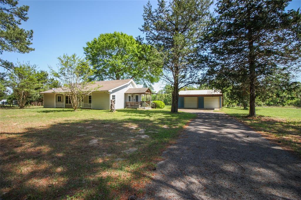Looking for a quiet place in the country to call home or home away from home? This could be it! Adorable 2 bedroom 2 bath siding home with 20x30 shop on 6.48 acres located 15-20 min east of Centerville & I-45 access. New HVAC (appr 1 yr), fresh paint, new ceiling fans and new flooring throughout. You'll love all the natural light in the living, dining & kitchen areas. The country kitchen features a huge breakfast bar overlooking the living/dining area, new gas range, new double sink & faucet & freshly painted cabinets. Sliding barn doors grace the closet in the ample guest room while the hall bath has a new vanity, toilet, lighting, mirror, tile floor & tub shower combo. The spacious primary bedroom has access to the front porch as well as a private bathroom with new vanity, lighting, tile floor & toilet. Enjoy the covered deck with built in bench, 20x30 metal shop on slab with two car carport on this half wooded half open 6+ acres. Simple country living is right here! Call today!