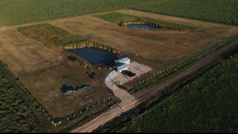 Fully fenced 10 Acres  features a storage building, carport to store all your equipment and 2 ponds.