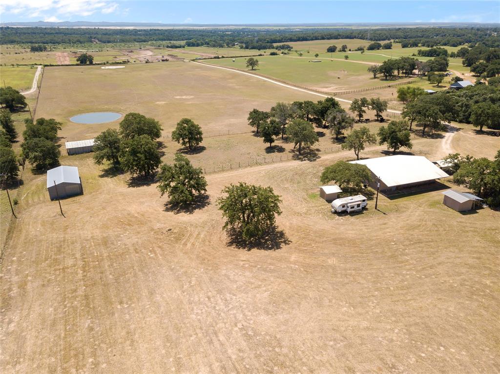 Welcome home to 43 acres of gorgeous, wide-open spaces! This improved pasture features 2 ponds, 2 barns, 2 sheds, perimeter fencing with cross-fencing & a cattle pin. 2 water wells - one services the home, one for the ponds & both include submergible pumps. Grazing pastures currently used for cows. Hay production in June yielded 70 round bales in just the back pasture alone. This Ranch style home features a commercial grade metal roof & 1-car detached carport, 3 spacious bedrooms, 2.5 baths, and a study. Open concept kitchen with large, eat-in island, oak cabinets, stainless steel appliances, brand new gas stove & a walk-in pantry. Primary bathroom features a walk-in shower, jetted tub, & double vanity. Secondary bathroom includes a new safe step tub!  Equipment & livestock are negotiable. All HVAC equipment replaced in 2020, & a whole house water softener recently installed. Don't forget about the 220V-hookup site for your RV, to provide additional living space as you build your dream