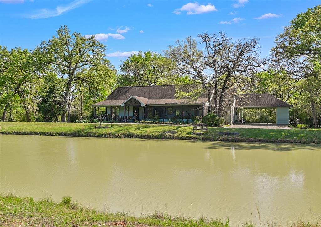 Located on 28.11 acres, this country estate offers a stunning 4 bedroom home, 1 bedroom guest house, beautiful ponds, and landscaping throughout the property. From the moment you enter the private gate, you will have the privacy of the country while being minutes from shopping, restaurants, and more in Bryan/College Station. The outstanding floor plan provides for a stunning living room with tall ceilings, wood beams throughout, and a fabulous fireplace. The kitchen is wonderful for entertaining, with a breakfast bar, island, and views into the living and dining area. The gorgeous master suite has a wonderful bathroom with a walk-in shower, bathtub, and large closet. The home also features three large bedrooms, and three full bathrooms. The beauty of the property continues to the guest house that has a full kitchen, bedroom, bathroom, and large covered pavilion. This home is one of a kind and something you do not want to miss!
