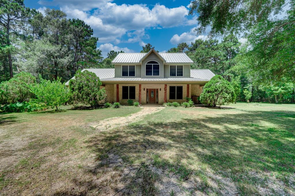 This beautiful 4 bedroom, 3 bath, partial 2-story home, metal roof, underground pool, large pond with live fish (includes a small fishing boat) on 10.4 acres is ready for you to come Home. Your home away from all. Your Oasis.  There are 2 Properties being sold together, Liberty Account #s 62712 and 62728. The 2nd property is .9 acres, for a total of 11.3 acres! The second property is connected to the main property and comes with a mobile home ready to be used as a guest home or income producing.
