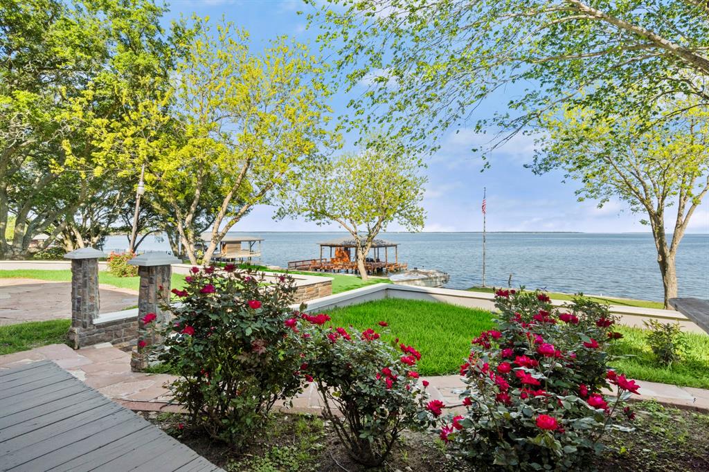 There are aspects that you can change about a property, but one thing you cannot change is the LOCATION! There is NOTHING COMPARABLE on LAKE LIVINGSTON or on most all lakes in TEXAS for that matter.This property consists of 3 adjoining lots.OVER 1 ACRE OF WATERFRONT LAND situated longitudinally on the lake instead of transversely,225'STEEL & CONCRETE BULKHEAD all DEEP WATER. Part of the big, deep WATER VIEW has no land in sight.PUSH THE NEIGHBORS AWAY. There are 13 BEAUTIFUL MATURE LIVE OAKS, & 3 MATURE PECAN TREES on the property.This FANTASTIC WATERFRONT ACRE includes it's very own concrete boat launch capable of accommodating large boats.An 8 inch thick concrete retaining wall surrounding the home & parking area secures the house 10' above the lawn for IMPECCABLE VIEWS, especially from the LARGE COVERED BACK PORCH.This is what awaits you at this location.NATURAL BEAUTY, PEACEFUL SETTING, VIEWS YOU CAN STARE AT ALL DAY, BREATHTAKING SUNSETS, & ONLY ONE LIKE IT ON THE ENTIRE LAKE!!