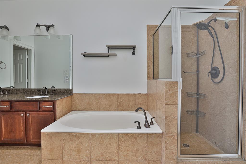 Primary bathroom has a large soaking tub and a separate shower.
