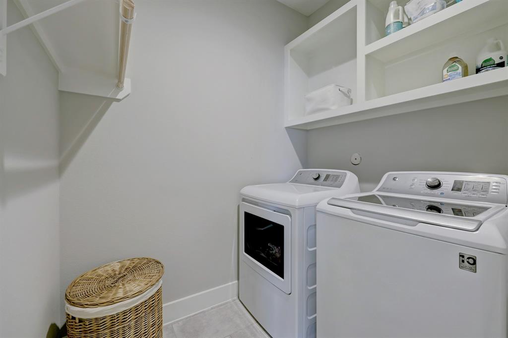 The second floor laundry room has a barn door similar to that of the under stair space in the kitchen.