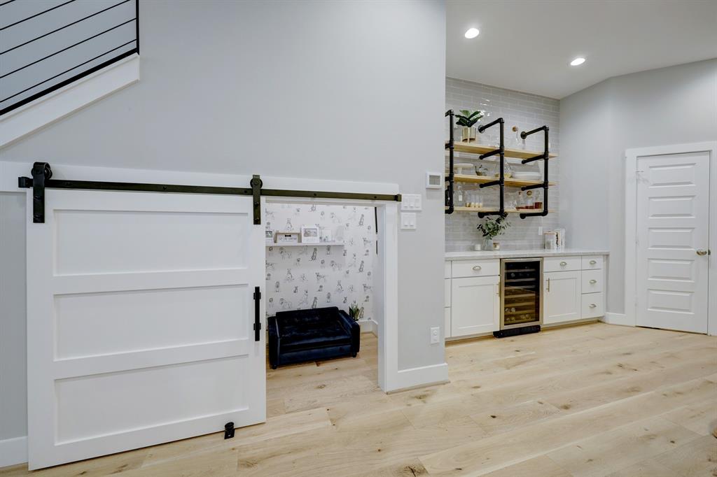 A custom option requested by the sellers is the under stair space finished with a barn door, created for their pups.  Alternately it serves as an additional storage space.