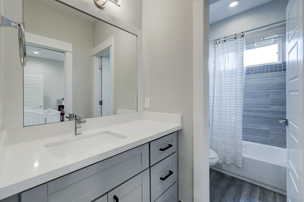 The shared bath offers a shower/tub combo and door between the sink area and shower/toilet room.