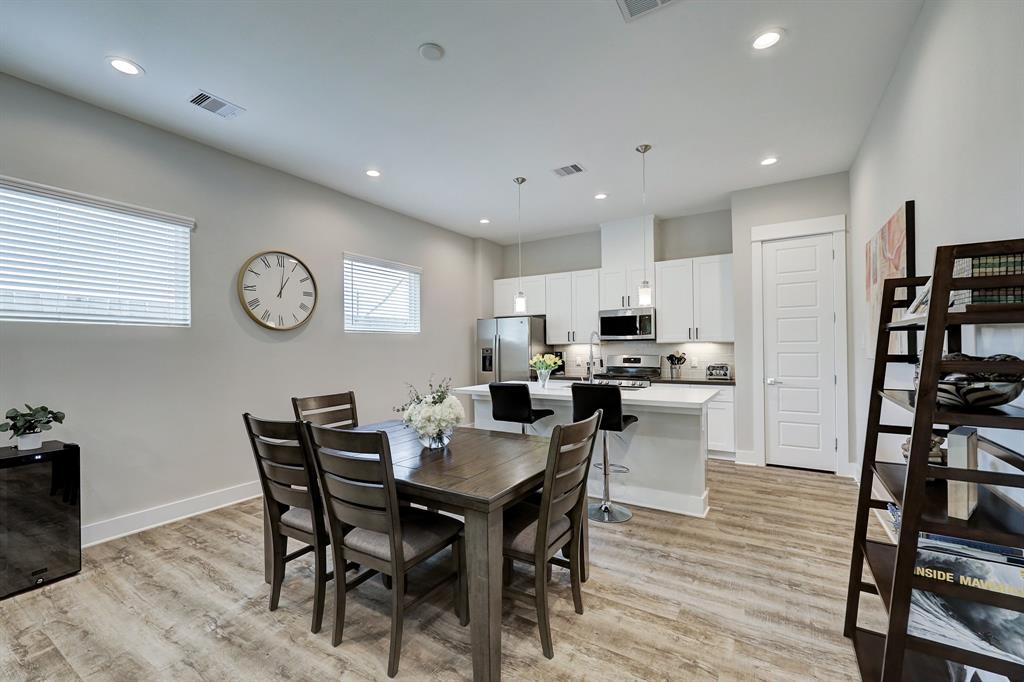 The dining area between the living space and kitchen could readily accommodate a larger dining set.