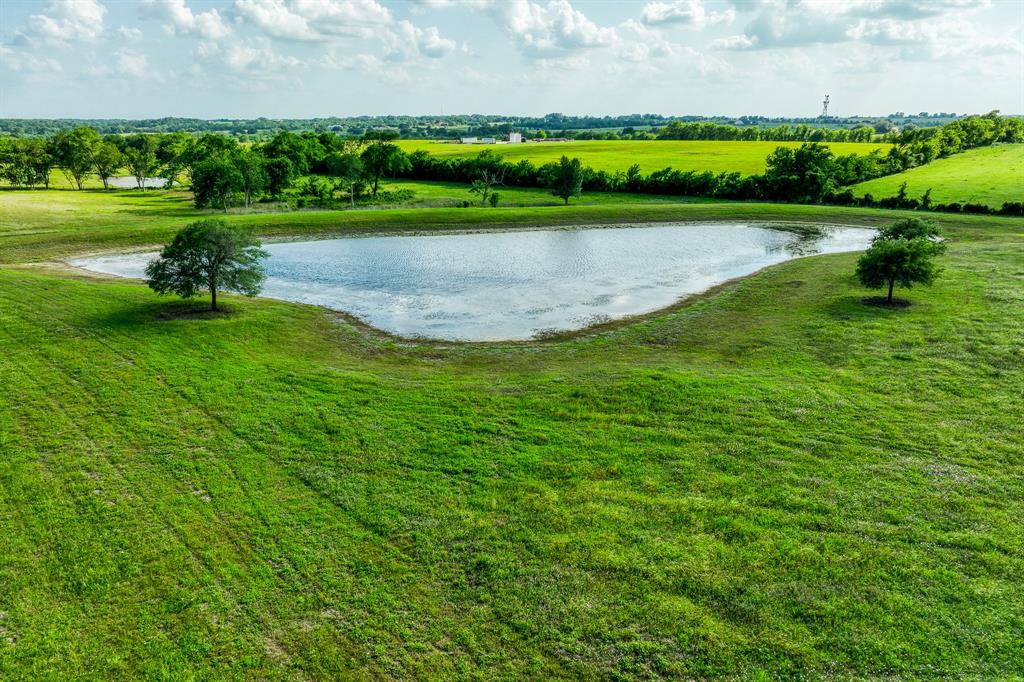 Beautiful acreage 2 miles off the Bahia Trail Fm 390. This tract has an excellent home site facing the 1.5 acre lake stocked with bass, brim, and bluegill. Picturesque farmland surrounds on all sides giving you a feel of privacy and calm. 20 minutes from Brenham and 34 minutes from Texas A&M Kyle Field. Easy access to food and college games.