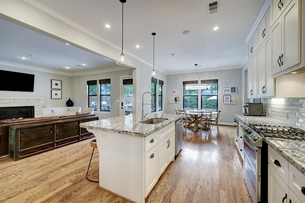 Directly across from the range, the island includes a deep single basin sink and elegant goose neck faucet.