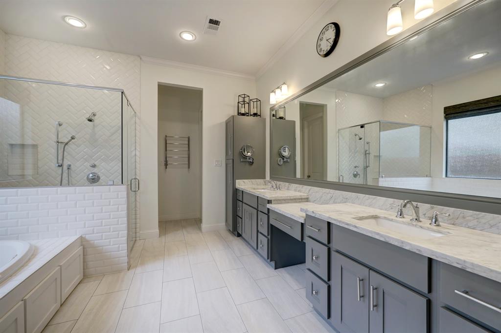 The primary bath of course includes dual sinks as well as a vanity area for sitting.
