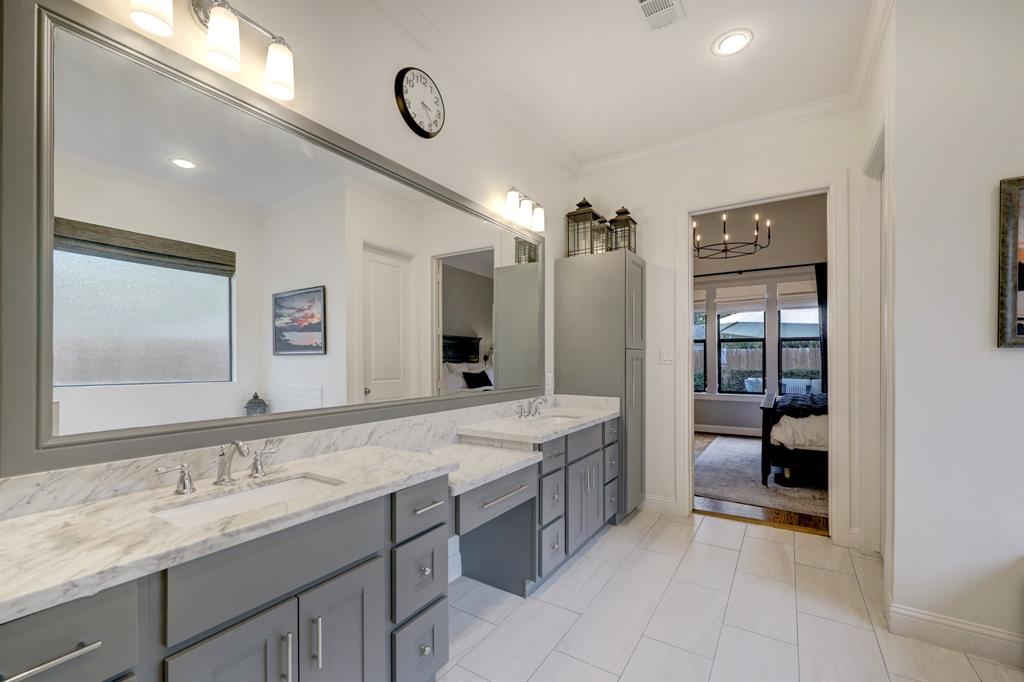 Linen and supply storage is exceptional between the under counter cabinets, drawers and cabinet towers on either side of the sinks.  The private water closet is to the right just inside the bathroom door.