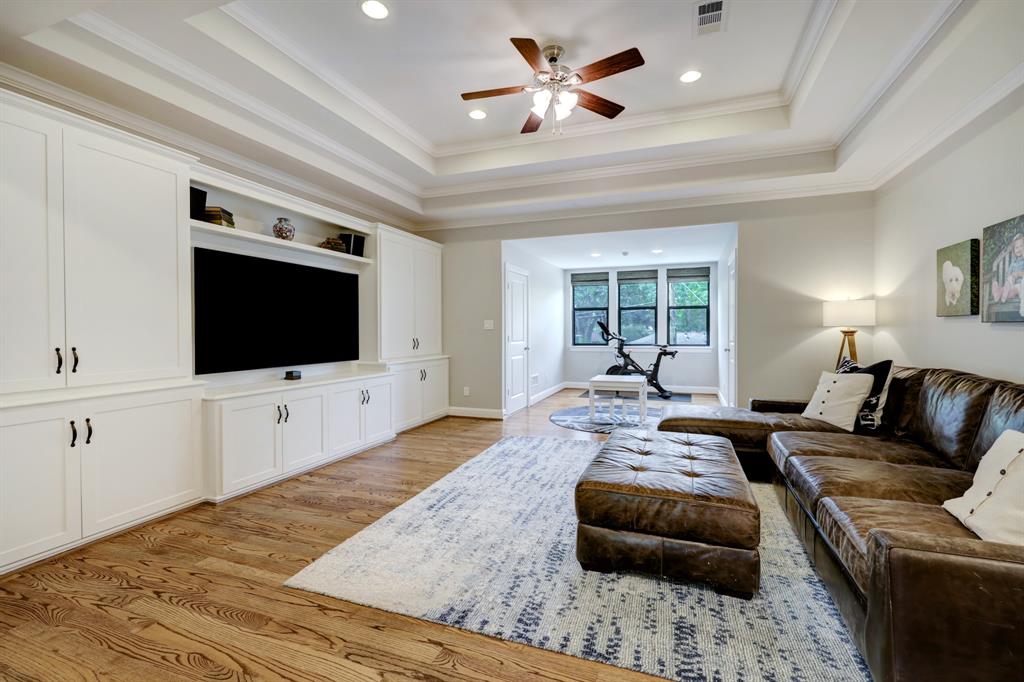 On the second floor is the massive media room/second living area with an architectural tray ceiling.  The current sellers installed the wall-to-wall built-ins.