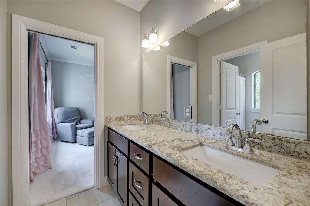 In the mirror of the shared bath you can see there is a shower/tub combo with a curtain.  The water closet space is private with a door separating it from the sink area.