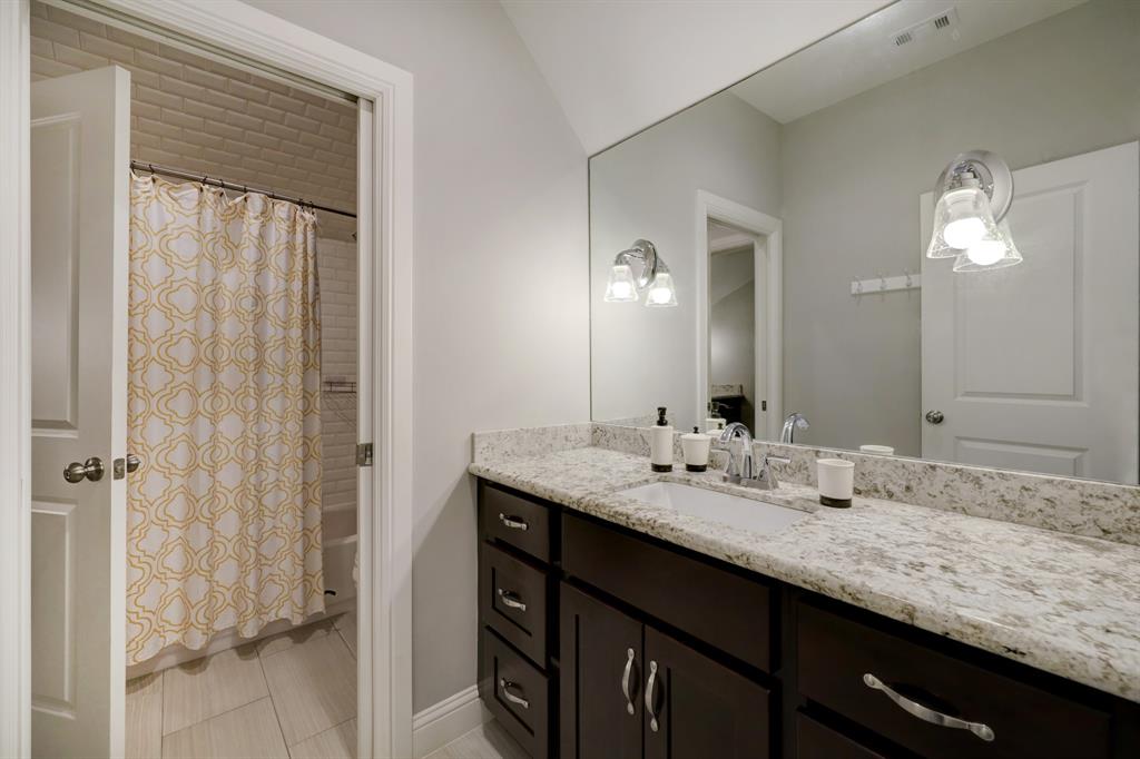 The third bath attached to the fourth bedroom has a private vanity for this suite, attached to the shower/tub combo/water closet.