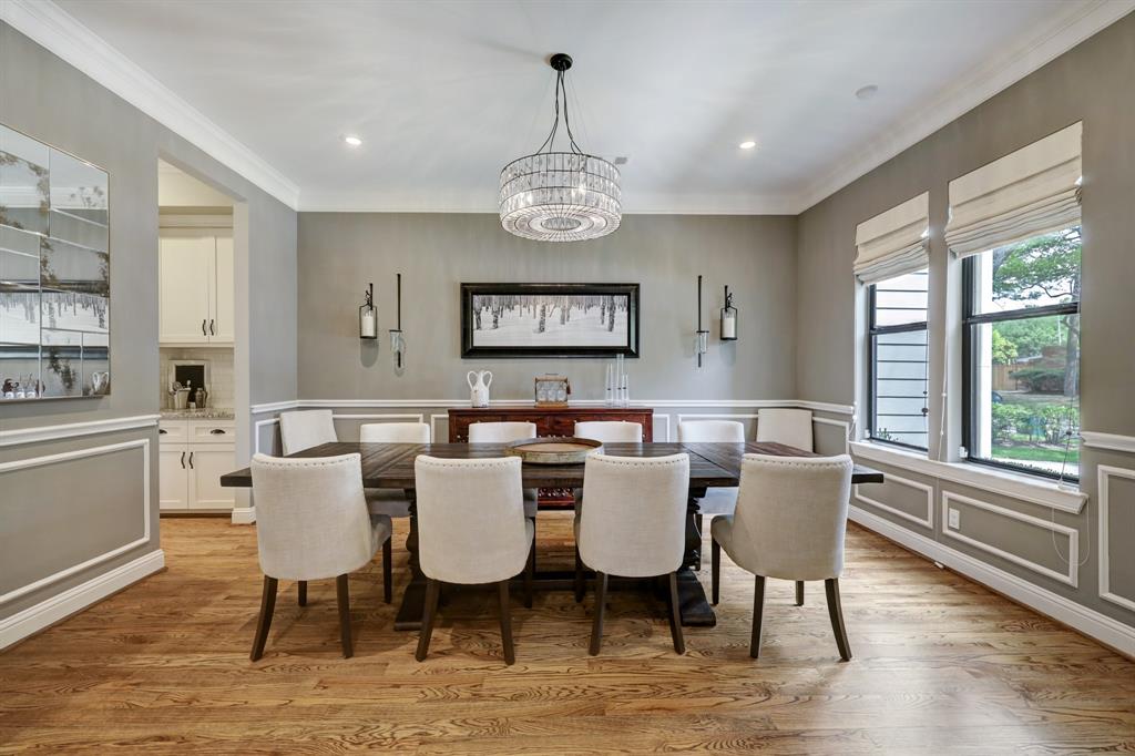 Also at the front of the home with views of the yard is a very large dining room.  This table comfortably sits 10.  The butler's pantry to the left leads to the kitchen and is adjacent to the mud and laundry rooms.