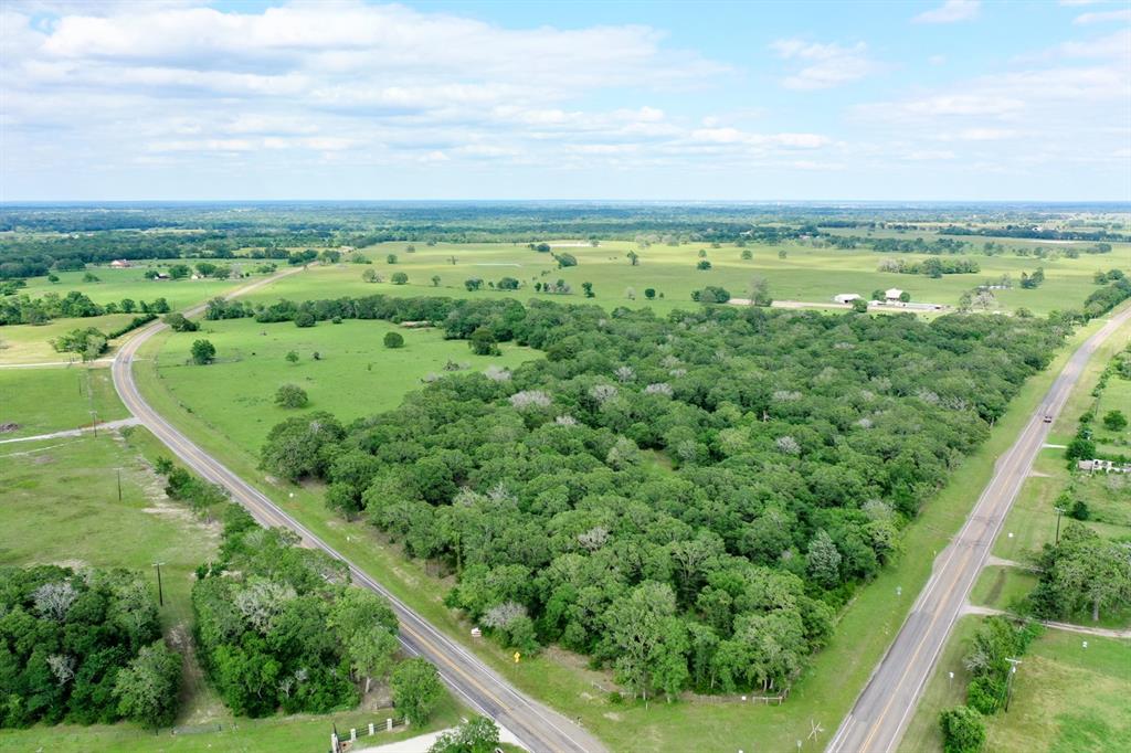Beautiful Wooded, Lot in Madison County with Light Restrictions is Ready for Your New Site Built Home or Barndominium. Tract 3 is a beautiful corner lot with 2 sides of paved road frontage: approximately 798' on FM 2158 and 675' on FM 1428. Presenting approximately 10% open, 90% wooded, this property offers many mature oaks, some softwoods and underbrush that creates a natural habitat for wildlife. This blank canvas is ready for small scale development intended for residential use; electricity is at the road; water and septic are needed. Additional acreage is available on the adjoining Lot 2. This property is conveniently located less than 10 minutes from I-45 access, approximately 30 minutes to Huntsville and 50 minutes to Bryan/College Station.