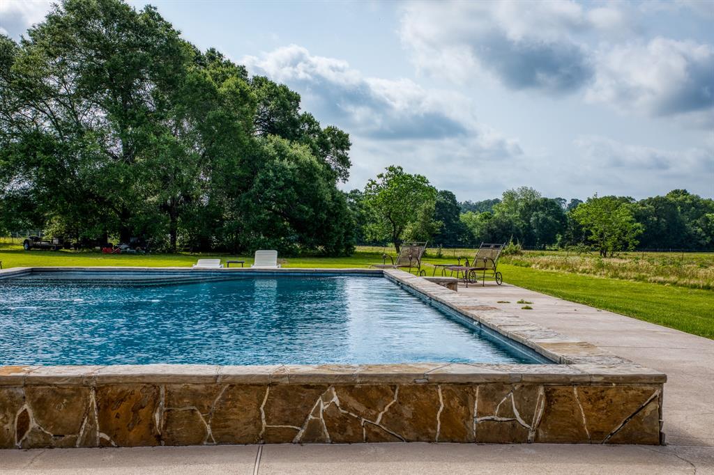This ranchette is an exceptional 11.5 +/- acres that has it all and only 6.5 miles from downtown Brenham. A charming 1800+sqft 2 bed/ 2 bath ranch house that boasts customized cabinetry, custom walk in pantry, vintage fixtures, and a luxurious crawl tub in the 2nd bath. Custom pool overlooking the tranquil landscape also has storage and outdoor facilities. Wrap around porch with stunning gardens will lend a seat for the show stopping sunsets. 3 oversized carports and RV hookups are in place for all the toys and 3 extra storage buildings. A second 1 bed/1 bath with loft cottage is ready for income producing STR or guest over flow. The property is a secluded gem lined with mature oaks, 3 acres of manicured pasture, a 2 acre pond, and 450ft of creek frontage. The property includes approximately 1.5 acres across the creek and abundant with wildlife. Ag exempt and a 2nd electricity meter in place for a future build. Fencing in place with tractor, implements, and trailer to convey.