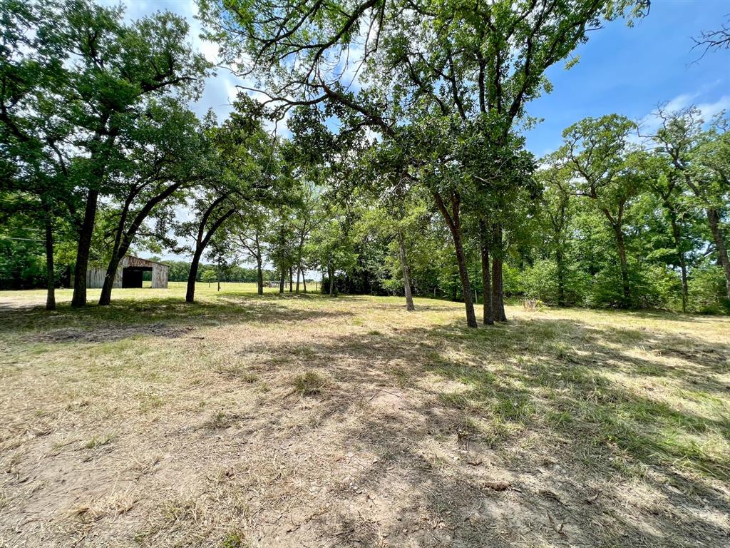 Multiple offers received. Please have offers in by 3:00PM on 5/20/22. Rare opportunity for an unrestricted site with utilities in place and an ideal arrangement of wooded area, open pasture, and scattered oaks. Amenities include: 30x50 barn, water well, MidSouth power, perimeter fenced, and paved frontage. Excellent building site! This one won’t last long!