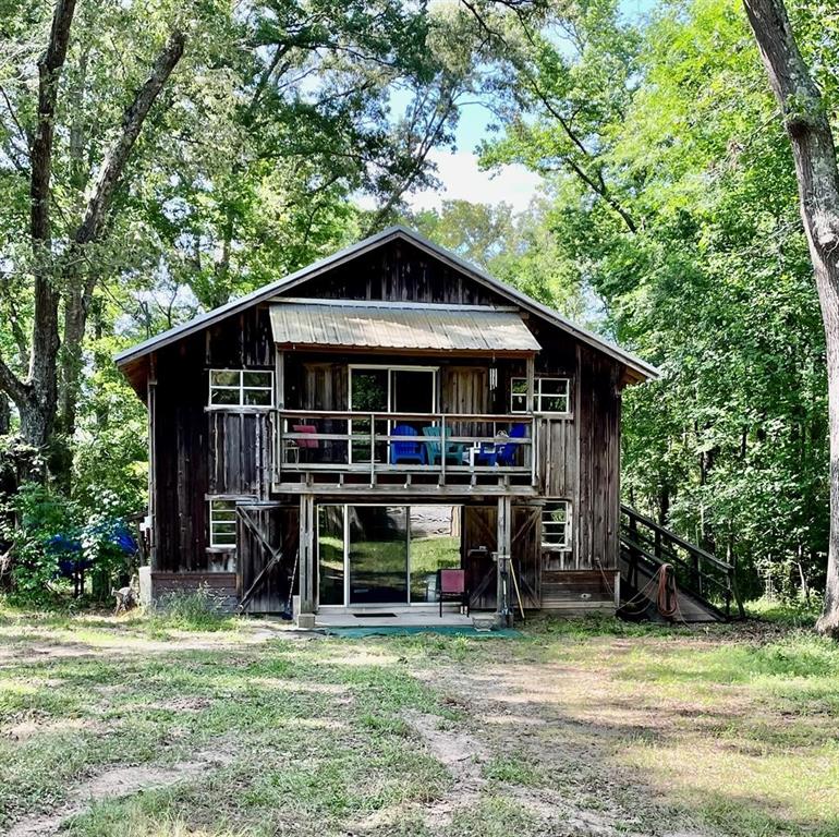 1289 County Road 388 Nacogdoches, Texas Come home to a place that you can really get away! Your childhood dream of living in a tree house can come to life on this peaceful property that boast of approximately 50 Pecan trees. This 20 acre secluded treasure has so many possibilities. Solid construction with open 'Loft Style' downstairs and upstairs. 2 bedroom, three bath with hog fencing around the house that allows plenty of space for your dogs to run. Property is fenced and crossed fenced. 2 car carport, hay barn, pole barn and a 40 x 30 metal shop with roll top doors. Hurry to see this one... you can slow the pace once you're here!