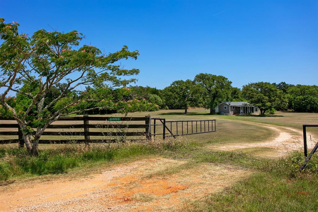 8893 CR 323 Caldwell, Texas Quiet, country retreat on +/- 3 Acres with updated Farm House in NW Burleson County. 3 Bedroom, 2 Bath Home,
with 2 en-suites, open kitchen/living area, covered front porch, freshly painted exterior and interior in May 2022.
Standing-seam, metal roof, hardy board siding, pier/beam foundation, Deanville Water Supply and new aerobic septic system being installed. The 3 acres is open with wooded tree-lined perimeter for privacy. County Road 323 is partially paved with a short distance of gravel road leading to the property. Sandy loam soil, perimeter fencing, quiet county road, no floodplain, no restrictions! Turn-key and move-in ready!