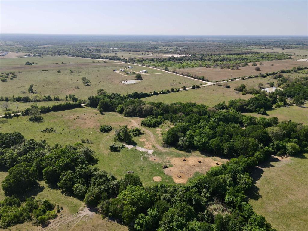 29 acres dotted with mature trees, live oaks, post oaks, and pecans. Two creeks meander through the property offering privacy and seclusion, as well as wonderful habitat for the wildlife. The improved pastures are ideal for horses or livestock to graze on. There are multiple building sites on the property as well. The gate is less than 10 minutes from I-10 and you are just over an hour to Austin, Houston, or San Antonio.  Come build your dream home and start enjoying the country life!