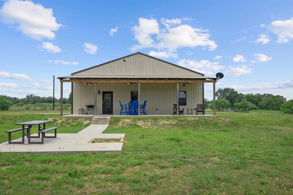 This fantastic hunting property is turnkey for the avid hunter! It is located just minutes from I-10 but tucked away far enough to have an abundance of wildlife. The property is 10 minutes from the town of Waelder, 20 minutes from Gonzales, 50 minutes from Bastrop and 30 minutes from Luling. The property taxes are kept low due to a Wildlife Exemption and wildlife spotted include turkeys, large whitetail deer, red deer, ducks and hogs. The property has a large pond that produces nice size bass and has a concrete spillway constructed in the last year. The barndominium is 2000sqft with 1150sqft living space and 850sqft shop space. The building was constructed so that the shop could easily be converted into more living space if desired. The building and well house are both fully insulated with a mixture of batts and blown-in insulation. All deer stands and deer blinds will convey. Too many details to list. It is a must see!