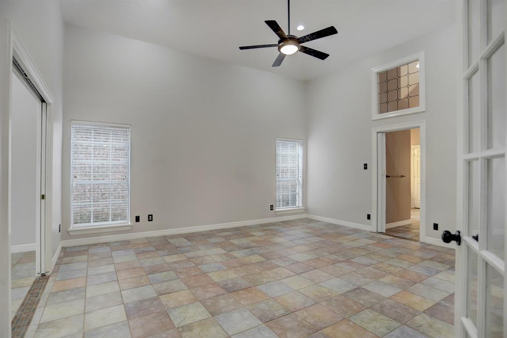 The roomy primary suite adjacent to the office feels even bigger than it is due to these glorious high ceilings. Split floorplan has 2 additional bedrooms upstairs.