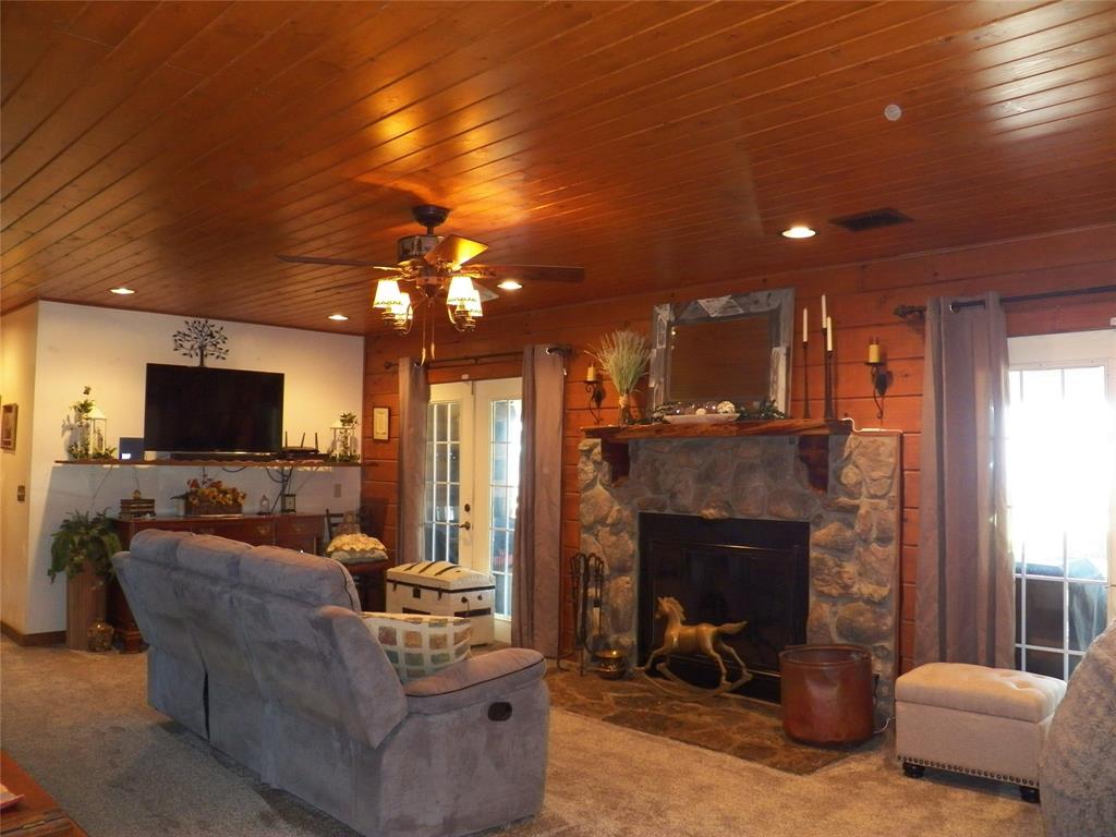 The Large Family room is so cozy and features the rock faced wood burning fireplace that is flanked by French Doors to the huge Back Porch, where lots of entertaining and large and small will happen - while overlooking the Trinity Bay and enjoying the breeze and passing boats in the distance.