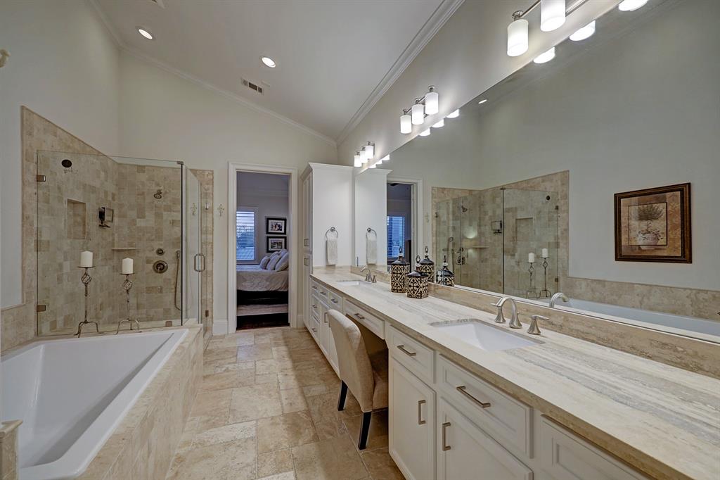 Artfully done primary bath with travertine and marble & lovely finishes.