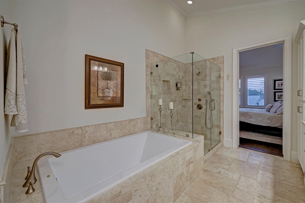 Artfully done primary bath with travertine and marble & lovely finishes.