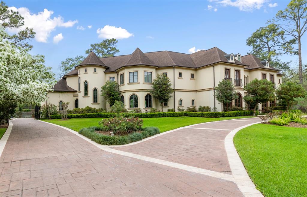 This custom home coalesces classic & contemporary elements to create an impressive residence, on a hidden cul de sac, in exclusive Piney Point, Memorial. Curved archways, two story ceilings & walls of windows provide soft transitions, large open spaces, & endless natural light throughout the almost 11,000sf interior. Flanked by a plethora of French doors and huge windows providing open views of the green foliage and curated grounds. A primary and secondary bedroom located on the first floor are on split sides of the home, offering privacy and leading out to the back yard and pool deck. At the center of the home is a large, open, and bright chefs' kitchen with floor through windows and an adjacent breakfast room overlooking the pool. A grand two-story wall of windows highlights the living room which looks over the large turquoise pool. The second level offers a theatre, game room with light kitchen open to a large terrace. An additional third floor open flex room with full bath awaits.