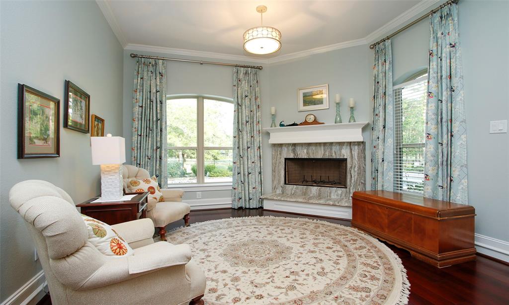 Large sitting area in the Primary bedroom that overlooks the pool area. Complete with a fireplace for those cold winter days.