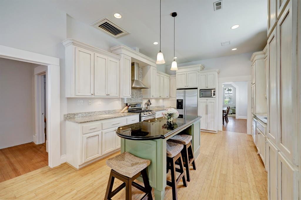 Multi-purpose island with built-in wine refrigerator,  added storage and a great spot for casual meals.