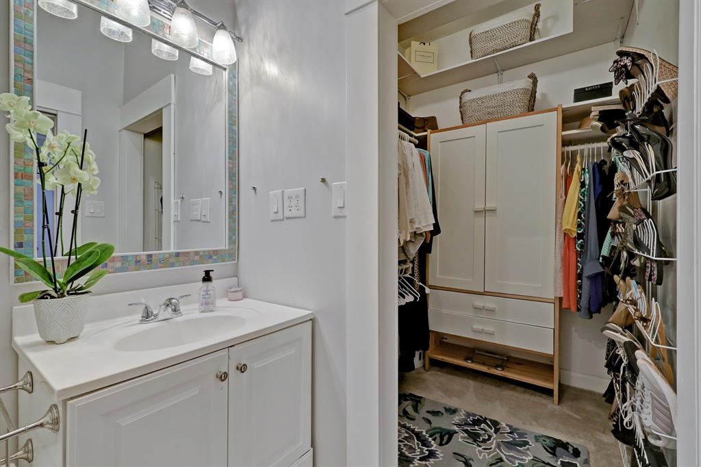 Primary bath with decorative tile, tub and shower option. Walk-in closet off bathroom.
